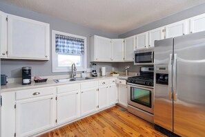 Kitchen: Bright and airy space with modern appliances, perfect for culinary adventures!