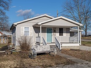 Charming Exterior: Step into tranquility with a welcoming porch and lush surroundings!