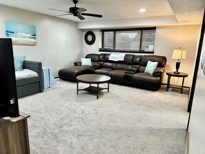 Lower level living area with trundle bed and lots of kids toys and books
