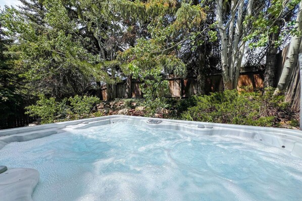 Summer relaxation starts here! Jump into the private hot tub for the ultimate vacation escape.