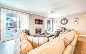 Comfy open living room area with plush seating and fireplace