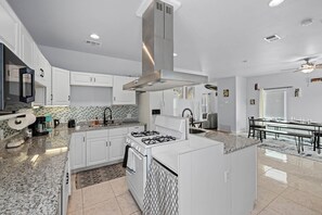 Fully equipped kitchen with high quality granite countertops.
