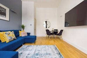Relax on the comfortable sofa and immerse yourself in a world of entertainment through our smart tv. Adjacent to the living area, you'll find a small dining area where you can enjoy your meals or catch up on work.