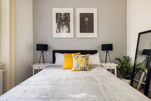 Relish in the comfort of our spacious king bed, the centerpiece of our inviting room. Accompanied by two stylish side tables, each adorned with a bedside lamp, our setup ensures a cozy and convenient space for relaxation.