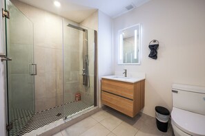 A sleek and spotless bathroom designed for your daily rituals. Fresh towels, essentials, and calming vibes included 