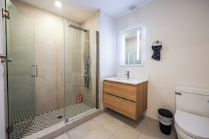 A sleek and spotless bathroom designed for your daily rituals. Fresh towels, essentials, and calming vibes included
