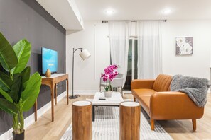 Immerse yourself in the harmonious fusion of style and comfort within our living room, featuring a vibrant ambiance that adds a lively essence to your stay. #LivingRoomVibes #ModernLiving #StyleAndComfort