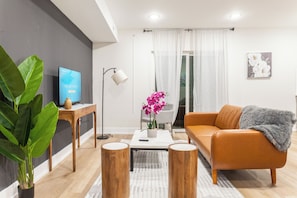 Immerse yourself in the harmonious fusion of style and comfort within our living room, featuring a vibrant ambiance that adds a lively essence to your stay. #LivingRoomVibes #ModernLiving #StyleAndComfort