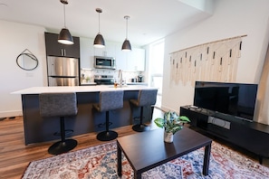 Discover the charm of an open kitchen layout, complete with a sleek bar table for casual dining and entertaining. #BarTableDining