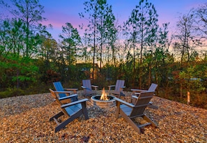 The outdoor fire pit area is calling—gather with friends or family for evening chats, toasted marshmallows, and an unbeatable view of the treetops at sunset.