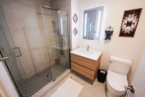 A sleek and spotless bathroom designed for your daily rituals. Fresh towels, essentials, and calming vibes included 