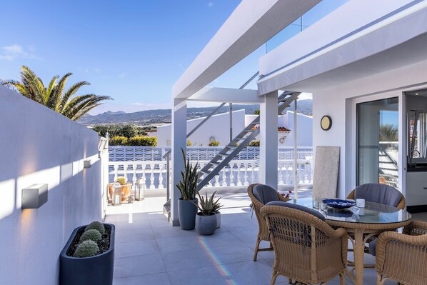 Beautiful spacious terrace with dining, sun loungers and hot tub