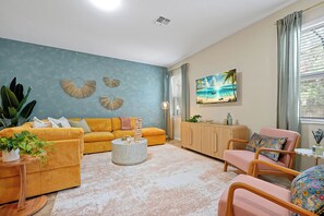 Whole area of the living room showing plush couches and TV