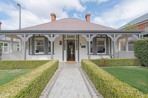 A striking façade and landscaped gardens welcome you to this beautifully preserved Federation-era residence, where modern comfort meets timeless elegance.
