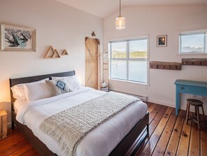 Queen bed in the upstairs loft style bedroom
