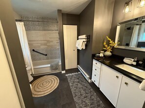 Large bathroom with laundry, tub/shower combo and lots of storage.