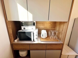 There is an oven, a range, a pot and a rice cooker.