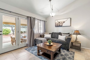 Open concept living room with direct access to the patio with a view.