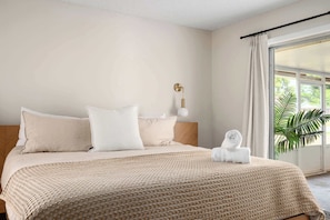 The natural wood accents and indoor plant add a touch of warmth and nature to the space. Come and enjoy the tranquility of our bedroom.