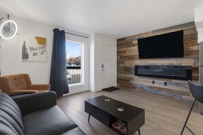 Curl up on the chic full-sized futon & stream your favorites on the smart TV