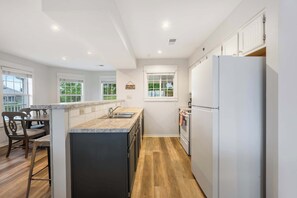 The open, airy kitchen offers ample space & every home comfort