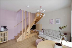 The wooden staircase and built-in storage create a unique feature.