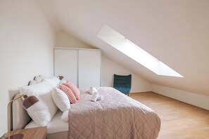 The bed is made with plush pillows and a quilted comforter.
