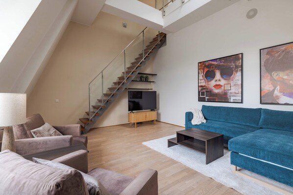 Comfortable seating arrangement with a neutral color palette and a modern TV stand.