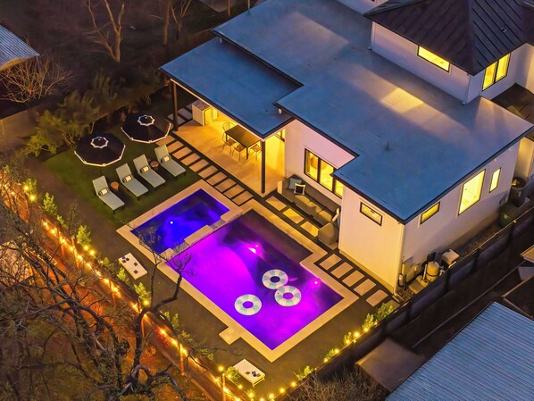 Check out this beautiful house with a sparkling pool and deck. Perfect for summer nights under the stars!