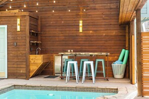 Relax by the pool and enjoy the outdoor bar area, perfect for unwinding after a day of exploring.