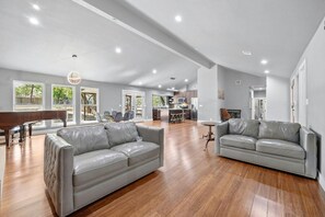 Gather in the open-concept living room with comfy seating and a smart TV. Perfect for movie nights or group conversations.