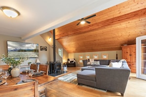 Open living room and dining room with wood burning stove
