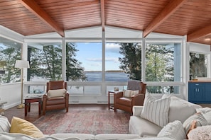 A wide view of Green Lake with windows extending across both the living room and the kitchen