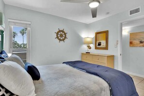 Coastal-chic bedroom; king bed & en-suite bathroom.
