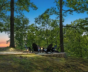 Views and trees surround a peaceful firepit.  Best place for morning coffee too!