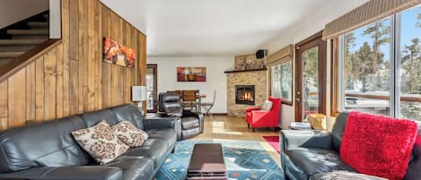 Living room: Smart TV, gas fireplace, leather seating for 7, access to deck, central heat, no A/C