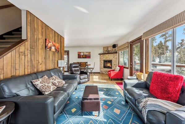 Living room: Smart TV, gas fireplace, leather seating for 7, access to deck, central heat, no A/C