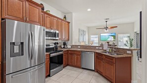The kitchen leads to the living room and completes the open floor plan layout.