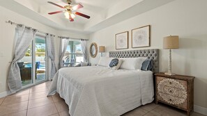 Access the rear porch from the sliding glass doors and enjoy views of the pool.