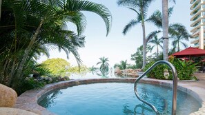 Unwind in Garza Blanca Puerto Vallarta’s hot tub with lush views & luxury vibes.