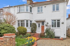 Front exterior of property with driveway and landscaped garden.