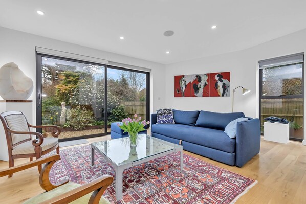 Spacious open-plan living area featuring a comfortable sofa and large windows