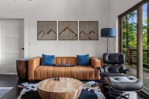 Classic chic furniture from Poly & Bark, an Eames chair, and stylish artwork on the main floor in the family room. 