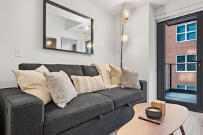 Unwind in our cozy living room, complete with a smart TV for streaming your favorite shows, and a pull-out couch for extra sleeping space.
