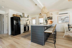 kitchen island with seating for 5 and dining table with seating for 4