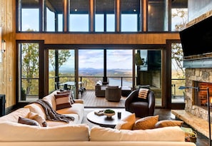 Watch the light change across the mountains right from the couch. These panoramic windows make every hour of the day feel magical.