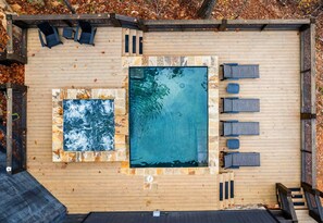 A bird's eye view of your private heated pool and sunny lounge deck, ideal for relaxing, playing, or taking in the fresh mountain air.