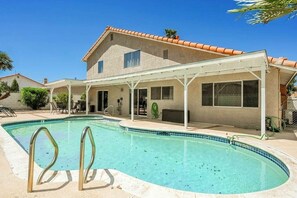 Sunny backyard with a private pool and comfortable seating.







