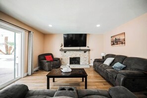 Inviting living room with cozy seating and a stone fireplace.
