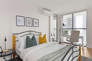 The 2nd bedroom on level 1 with a double sized bed & plush pillows.